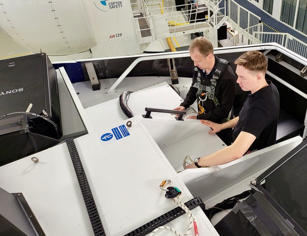 A maintenance team member and the instructor looking at the various attachment points 